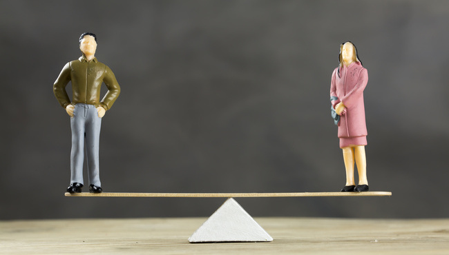 Balanced Scale With a Man and Woman