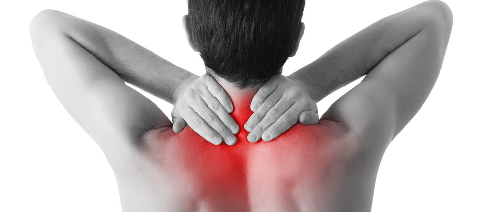 Rear view of a young man holding his neck in pain, isolated on w