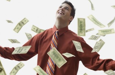 corbis - soldi - Money Falling on Happy Businessman --- Image by © JLP/Jose L. Pelaez/Corbis