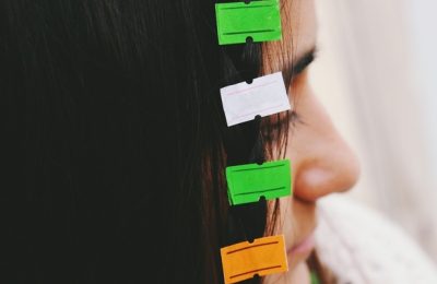 Closeup image of young womans hair attached to empty price tag l